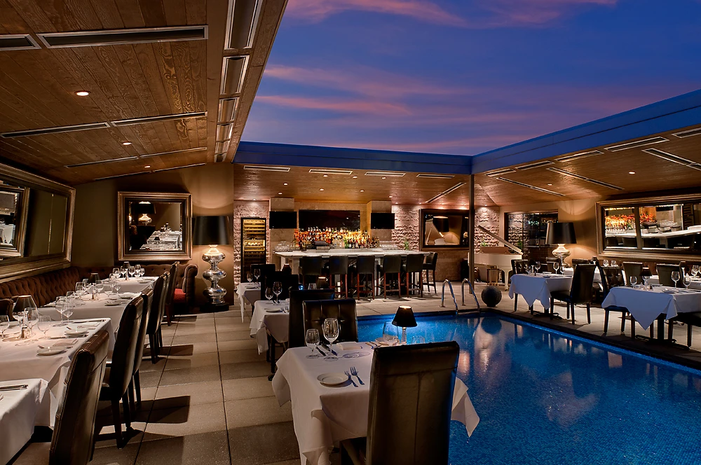 https://www.dominickssteakhouse.com/wp-content/uploads/2025/06/Dominicks-Steakhouse-Rooftop-Poolside-Dining.webp